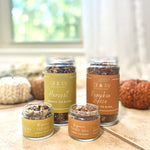 Four jars of 'Oil & Joy' tea blends on a kitchen counter with blurred background