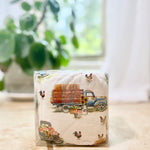 Packaged cherry pit therapy pack with a farm-themed design featuring trucks and chickens on a neutral background.