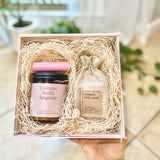 Gift set with lavender vanilla tangerine candle, lip balm, and bath soak in a decorative box.
